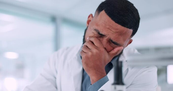 Scientist, stress and headache for computer research, planning and data analysis, mistake or healthcare results. Sad, frustrated or tired science man or doctor working on laptop in medical laboratory
