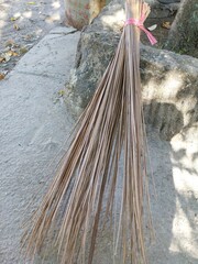 broom sticks made from coconut leaf ribs for sweeping up rubbish.
