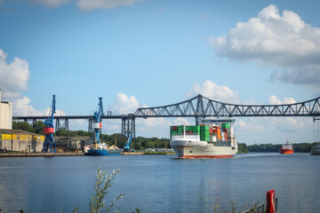 A container ship passes under the Rendsburg high bridge