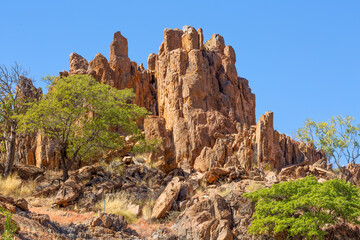 A jagged rocky outcrop with green trees in Gulf country in Northern Queensland, Australia.