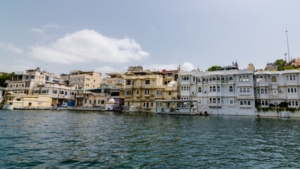 Fototapeta na wymiar Udaipur, Rajasthan - Buildings on the bank of Lake Pichola an artificial fresh water lake situated in Udaipur