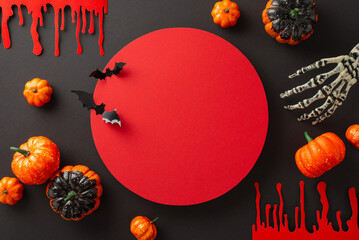 Menacing Halloween tableau: Top view composition with blood trails, skeleton hand and thematic...