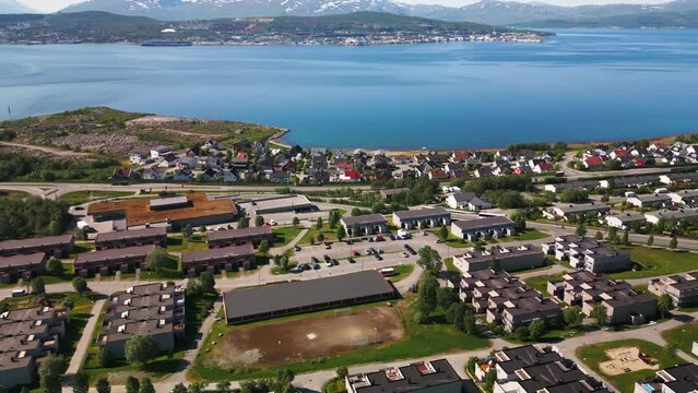 Tromso neighborhood on banks of fjord in Norway, scenic aerial view