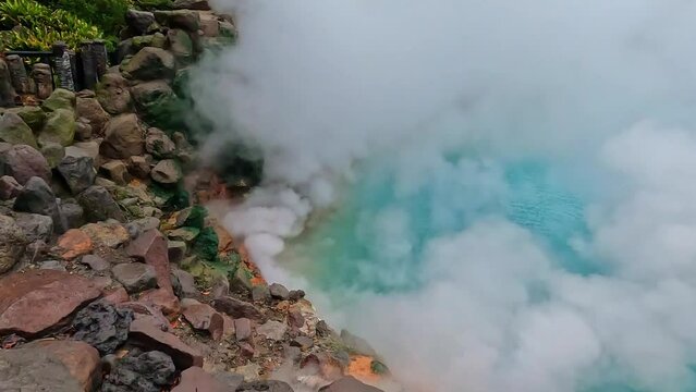 umi jigoku or sea hell taken in beppu with steamy hot springs geyser steaming off the cobalt water. steaming geyser. Taken in Beppu, Japan. Beppu, Japan hot springs at kamado jigoku.