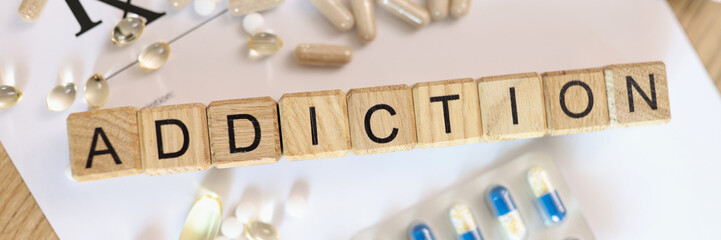 Addiction word collected with wooden cubes and medicines