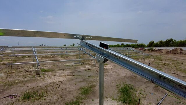 Digital protractor paced on solar panel array steel beam structure measuring tilt angles