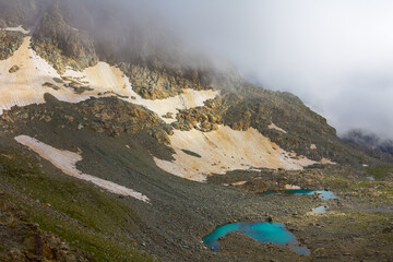 mountain ridge with glacier in dense mist