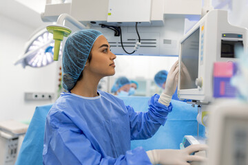 Concentrated Surgical team operating a patient in an operation theater. Well-trained anesthesiologist with years of training with complex machines follows the patient throughout the surgery.