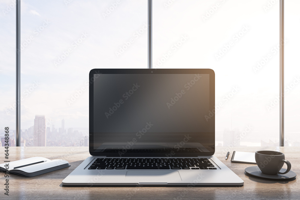 Poster close up of laptop with empty mock up monitor, coffee cup and notepad placed on wooden desktop. wind