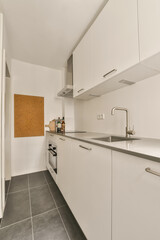 a kitchen with white cupboards and appliances on the counter top in front of the sink is an open door