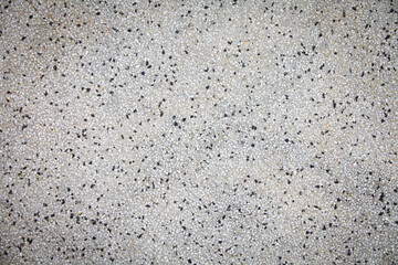 Cement mixed small gravel stone wall or floor texture background,The Dust Texture. Abstract dense splash texture. Random pebble gravel oval elements seamless pattern.