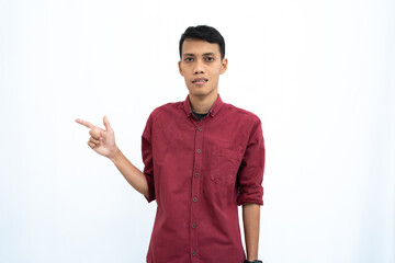 asian man, businessman or student concept wearing red casual shirt posing looking to the side of copy space with happy or surprised face. Isolated white background.