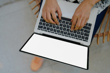 A person working on a laptop in concept business work top view of blank white screen laptop computer