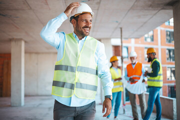 Portrait of satisfied and confident engineer with helmet and news on building site. Close-up...