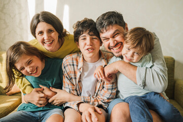 Happy family together sitting on sofa and having fun at home