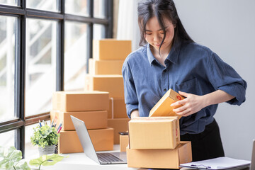 Small business aspiring young asian entrepreneur SME, small and medium business freelance worker working in a home office.SME online business ideas.