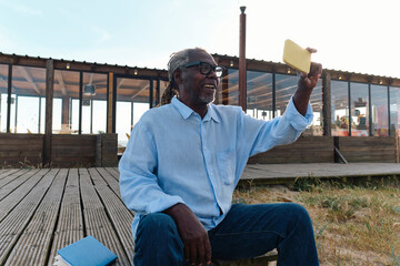 Happy engineer taking selfie through smart phone on sunny day