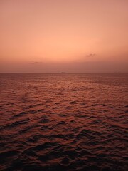 Violet Sunrise on The Sea with A Ship on Horizon