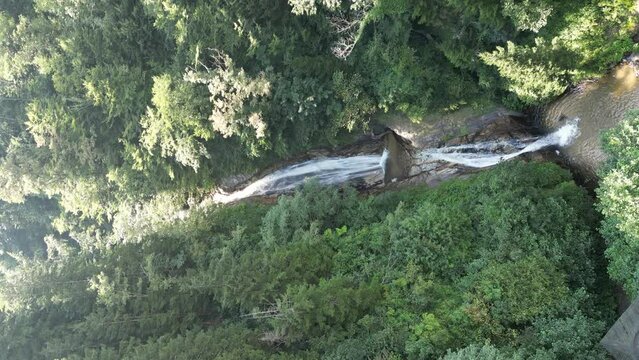 Rize manle waterfall. Aerial view of beautiful waterfall in green forest. Natural waterfall flowing from the Black Sea mountains. Drone view. Rize Turkey. vertical shot waterfall image. Story format