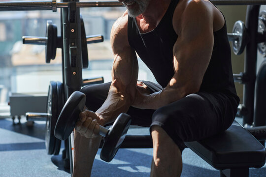 Man exercising with dumbbell in gym