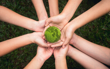 world environment day hand holding green globe on green background Environmental protection and...