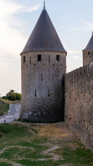 Fototapeta na wymiar Old romanic tower with a wall in Carcassonne