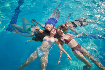 Happy friends together swimming in pool