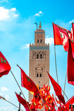 Morocco, Marrakesh-Safi, Marrakesh, Moroccan flags in front of Kutubiyya Mosque