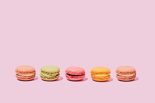 Colored macaroons on pink background