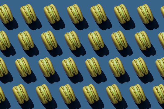 Background of green macaroons over blue background