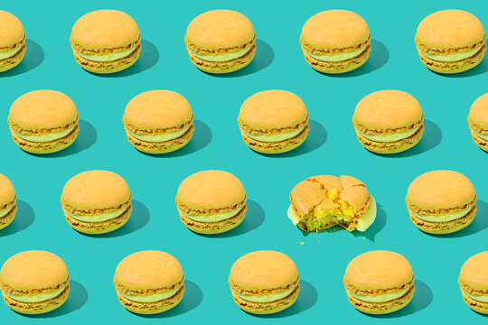 Yellow macaroons arranged on colored background