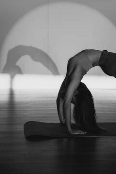 Young woman practicing bridge position in health club