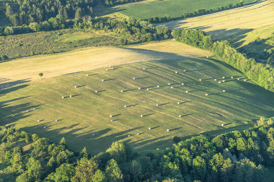 Germany, Saxony-Anhalt, Aerial view of hay bales drying in green field