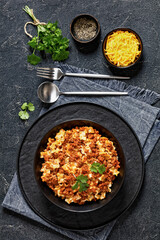 Lasagnette bolognese in black bowl, top view