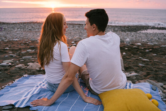 Smiling Young Romantic Couple Talking At Beach On Vacation