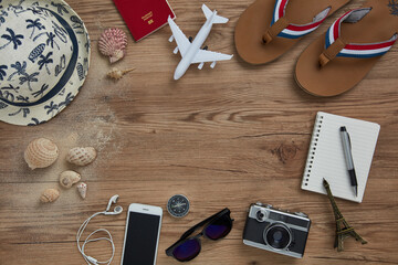 top view of travel gadgets on wooden  background for travel concept