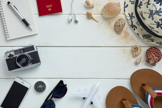 top view of travel gadgets on white wooden  background for travel concept