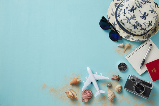 top view of travel gadgets on blue background for travel concept