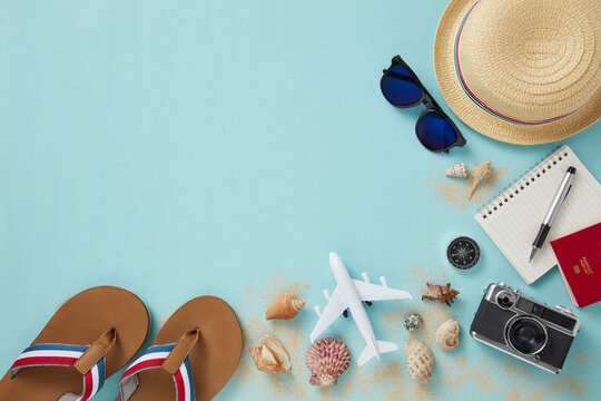 top view of travel gadgets on blue background for travel concept