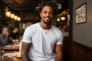 Fototapeta premium A Young Man Showcases Bella Canvas White T-Shirt and Jeans, Savoring Sunshine at a Charming Restaurant, Featuring a T-Shirt Design Template and Print Presentation Mockup.. created with Generative AI