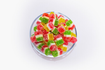 colorful marmalade in sugar on a plate, top view