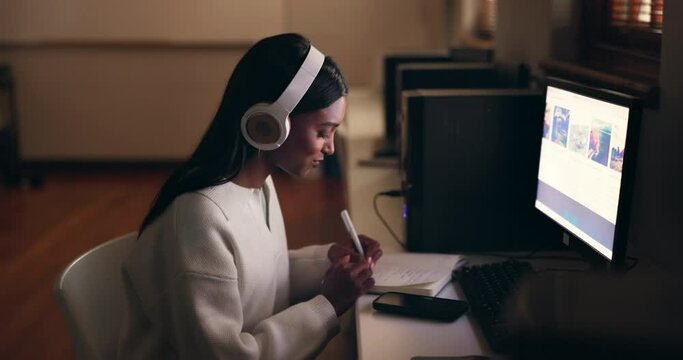 Business, headphones and woman writing, night and computer screen with research, planning and listening to sound. Person streaming music, dark or employee with a headset, pc or notes with inspiration