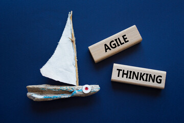 Agile Thinking symbol. Wooden blocks with words Agile Thinking. Beautiful deep blue background with boat. Business and Agile Thinking concept. Copy space.