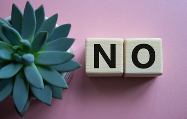 No symbol. Concept words No on wooden blocks. Beautiful pink background with succulent plant. Business and No concept. Copy space.
