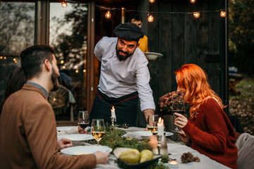 The chef serves food and curates an unforgettable culinary experience for the people.