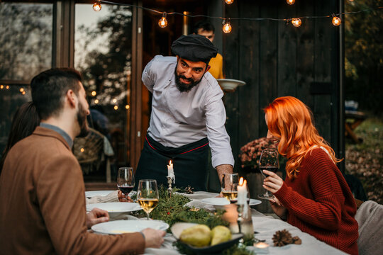 The chef serves food and curates an unforgettable culinary experience for the people.