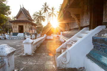 Tourists appreciate the ancient Buddhist temple in Luang Prabang. - 644381066