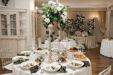 Floral wedding decoration. The wedding table setting is decorated with flowers. Wedding floristry. Wedding menu.