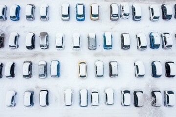 A snow-covered parking lot in winter with cars seen from above. Generative AI - obrazy, fototapety, plakaty