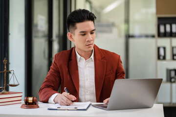 Fototapeta premium Male lawyer working at table at home office in the morning.